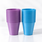 Two stacks of Posi Shield 5 oz. dental plastic cups with a ribbed exterior, one in lavander purple and the other in bright blue, set against a clean white background.