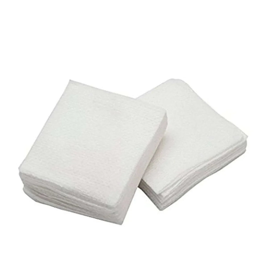 Two stacks of white 2x2 non woven gauze for dentists

